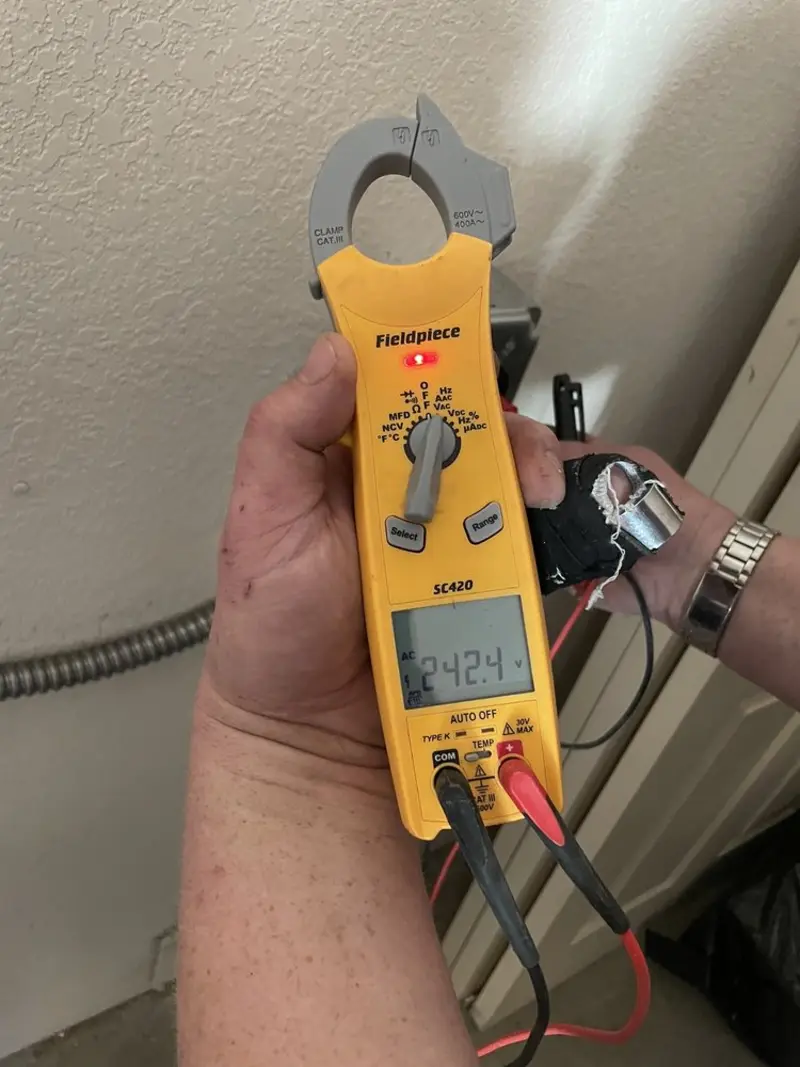 Voltage testing with clamp meter during Outlet Installation in Harlan